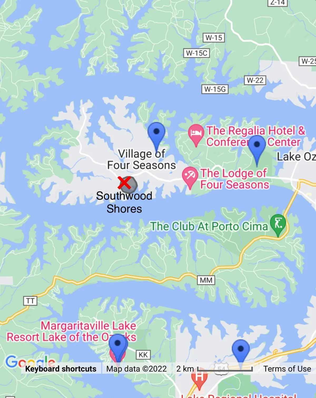A sweeping view of the Lake of the Ozarks area, highlighting notable locations such as the Village of Four Seasons, Margaritaville Lake Resort, Southwood Shores, and The Club At Porto Cima. The lake stretches into the distance, capturing the region's adventurous spirit and scenic beauty.